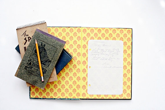 She pasted her note  into the book on lined notebook paper.